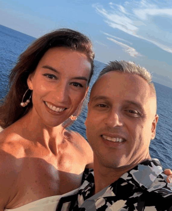 A man and a woman posing for a picture on a boat