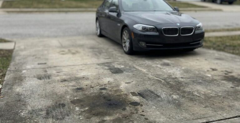 A black car parked on the side of a road