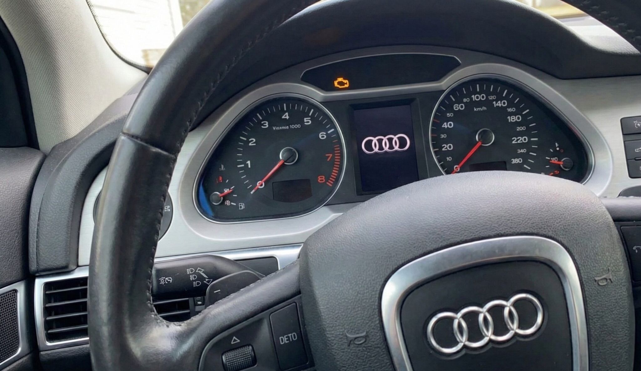 A steering wheel and dashboard of a car